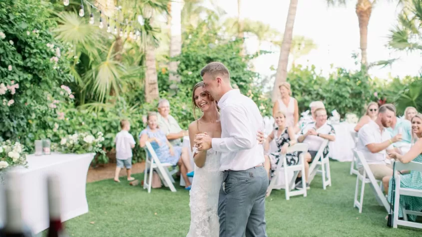 beach wedding reception greenery bride and groom kiss sundial sanibel